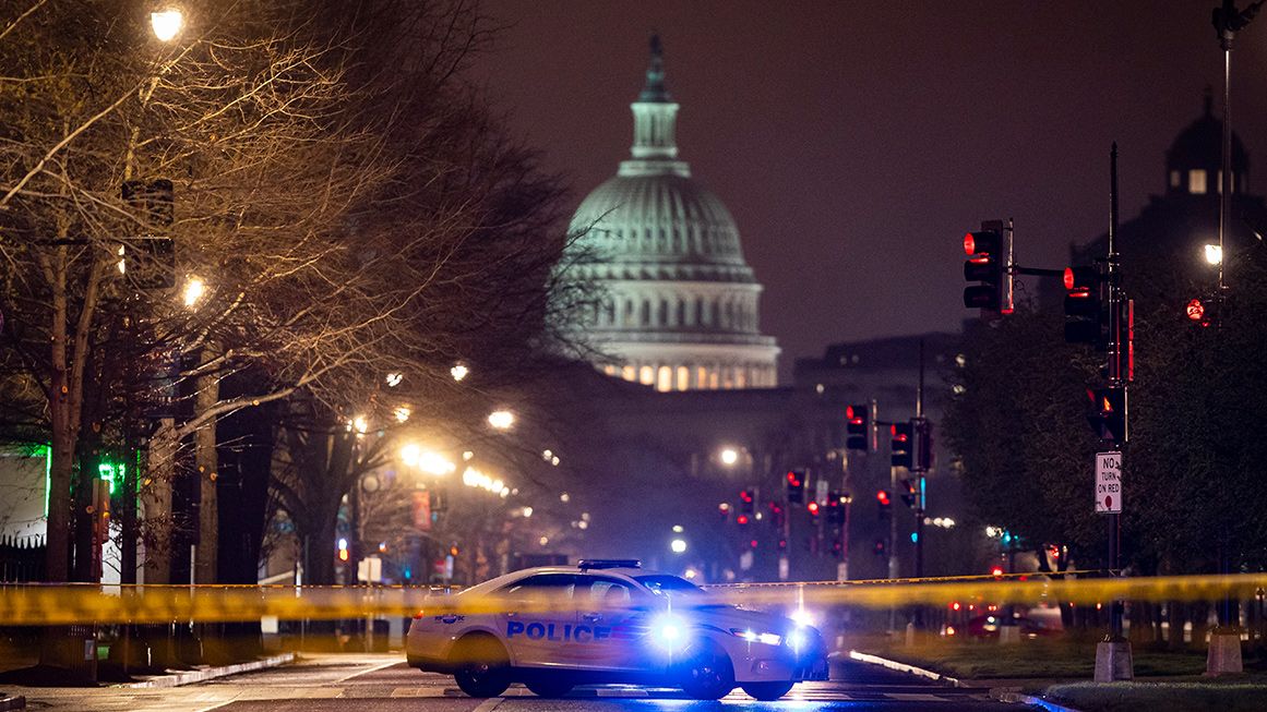 A photo of the U.S. Capitol at night with a police car blocking the street in the foreground | Photo: Al Drago/The Washington Post/Getty
