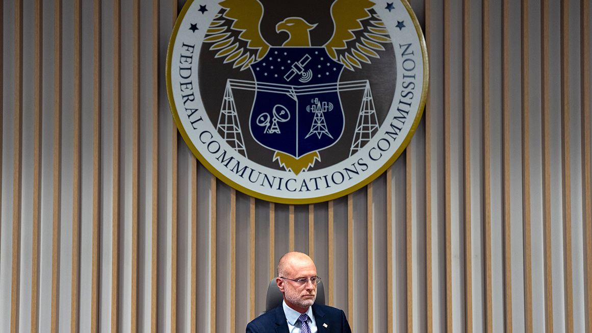 Brendan Carr sitting beneath the FCC seal | Photo: Federal Communications Commission Chairman Brendan Carr; Kent Nishimura/Bloomberg/Getty