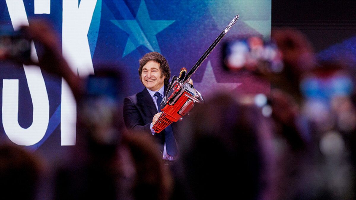 Javier Milei wielding a chainsaw in front of a crowd | Jason C. Andrew/Bloomberg via Getty