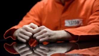a person wearing an orange prison jumpsuit