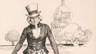 book1 | Photo: Uncle Sam rounding up men labeled “Spy,” “Traitor,” “IWW,” “Germ[an] money,” and “Sinn Fein,” with the United States Capitol in the background