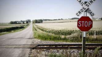Rural railroad crossing in front of dirt roads and fields |  Stuart Monk/Dreamstime.com