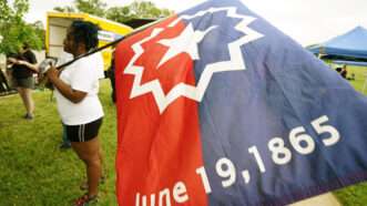 woman holding Juneteenth flag | BILL GREENBLATT/UPI/Newscom