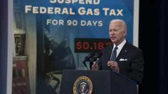 Biden is standing at a podium talking about lowering the gas prices.