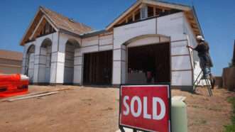 Picture of a house under construction with a sold sign in the foreground | Randall Benton/TNS/Newscom