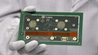 A scientist is holding a semiconductor computer chip | JOHN THYS/Belga/Sipa USA/Newscom