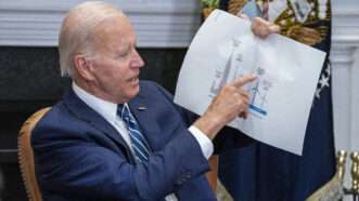 Biden points to a wind turbine graph on a piece of paper | Shawn Thew / Pool via CNP / SplashNews