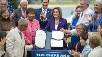 Nancy Pelosi is holding a signed bill outside with other members of Congress | BONNIE CASH/UPI/Newscom