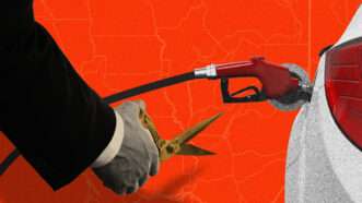 A man holding scissors goes to cut a traditional gas pump filling a white car on a red background