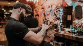 man cutting hair in a barber shop
