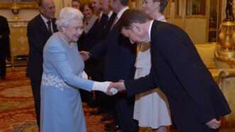 Queen Elizabeth shakes someone's hand | Anthony Devlin/ZUMAPRESS/Newscom