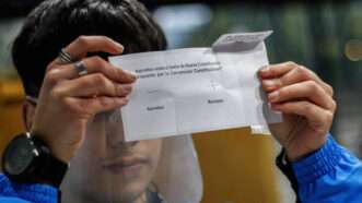 Chilean voter holding a ballot