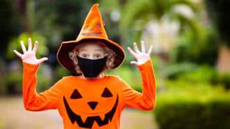 Kid in Halloween costume and mask
