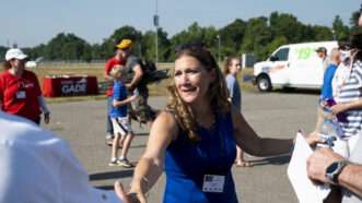 Tina Ramirez shaking hands in a parking lot. | Bill Clark/CQ Roll Call/Newscom