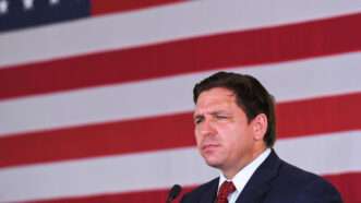 Florida Gov. Ron DeSantis speaks in front of the American flag | Paul Hennessy/ZUMAPRESS/Newscom