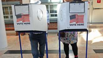 Two voters in Queens at early voting booths | Andrea Renault/Polaris/Newscom