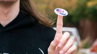 woman with "I Voted" sticker on her finger