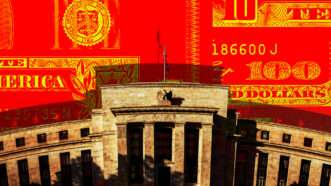 The Federal Reserve is seen in front of red 100-dollar bill