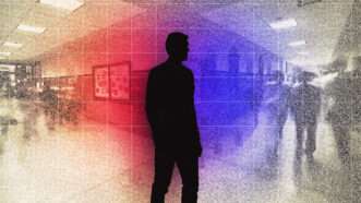 The silhouette of a principal is seen at a school
