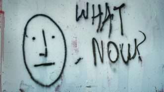 Graffiti with concerned face and the words "What Now?"