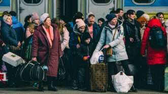 Ukrainian refugees wait to board a train in March 2022