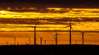 Wind energy turbines are seen at sunrise | Photo 53582516 © Bryan Roschetzky | Dreamstime.com