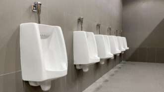 A row of urinals in a public men's bathroom. | Tapanakorn Katvong | Dreamstime.com