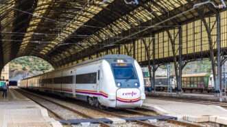 A Renfe high-speed train sitson the track at a rail station. | Leonid Andronov | Dreamstime.com