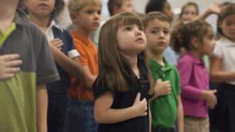 Children reciting the pledge of allegiance. | Image Source/Newscom