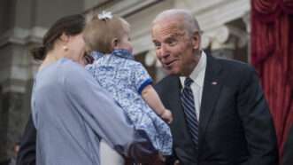 Joe Biden greets a small child | Tom Williams/CQ Roll Call/Newscom