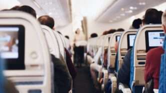 People sitting in seats on a flight