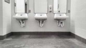 Three sinks and mirrors in a public restroom. | Stephan Pietzko | Dreamstime.com 