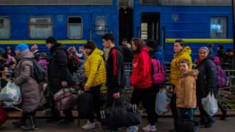 Ukrainian refugees from Mariupol step off a train in Lviv