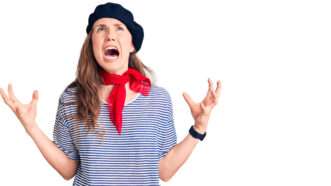 A blonde woman in a beret and a black-and-white striped shirt with a red kerchief, screaming. | Aaron Amat | Dreamstime.com