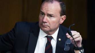 Sen. Mike Lee (R–Utah) at a Senate Judiciary committee meeting. He is holding his glasses in one hand and looking off to the side. | Tom Williams/CQ Roll Call/Newscom