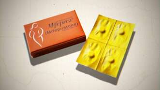 mifepristone pills and packaging against a gray spotlit background | Erin Hooley/TNS/Newscom