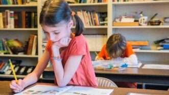Girl in classroom | Guido Koppes/agefotostock/Newscom