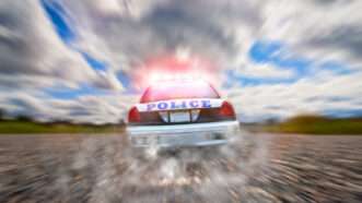 A police car in hot pursuit. | Janis Lacis | Dreamstime.com