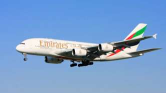 Emirates airplane flying in the sky | Photo 12469944 / Airlines © Gordon Tipene | Dreamstime.com