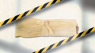 Caution tape pictured over a tamale