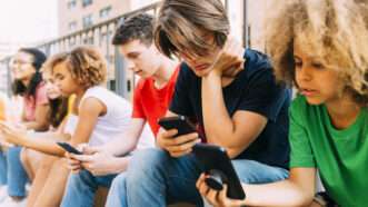 Teens using their phones for social media | Eugenio Marongiu/Westend61 GmbH/Newscom