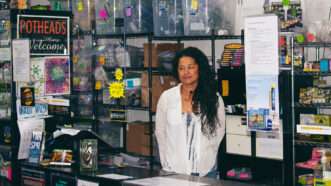 Maria Elena Reimers standing behind the counter at the marijuana dispensary Cannarail Station.