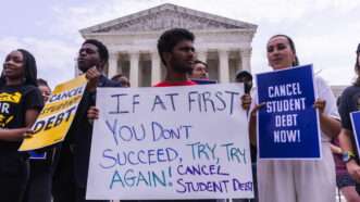 Protesters stand outside the U.S. Supreme Court building with signs calling for President Biden to continue trying to cancel student loan debt.