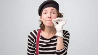 Female mime pretending to zip her mouth shut. | Viktor Koldunov | Dreamstime.com