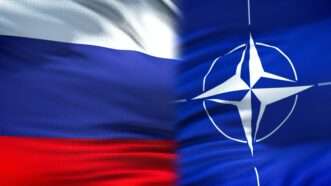 NATO flag and Russian flag | Photo 137519128 © motortion | Dreamstime.com