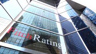 Looking-up shot of a building with the Fitch Ratings logo. | King Ho Yim | Dreamstime.com