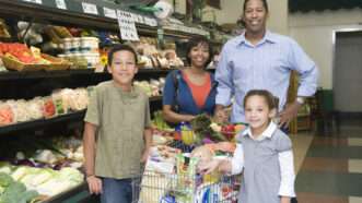 Family of four shopping at the supermarket. | Photographerlondon | Dreamstime.com