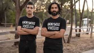 two animal rights protesters, Daraius Dubash and Faraz Harsini, stand arms-crossed in a park wearing "Anonymous for the Voiceless" T-shirts. | Photo: Saturn Photography
