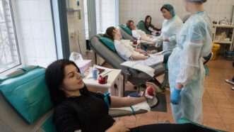 Woman is giving blood in a blood transfusion clinic | Photo 105590782 © Igor Akimov | Dreamstime.com