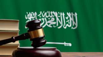 A judge's gavel against the backdrop of the flag of Saudi Arabia. | Sergei Babenko | Dreamstime.com